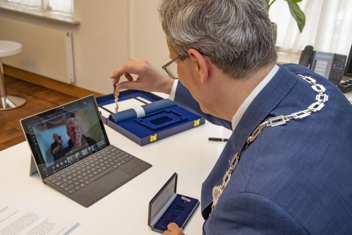 Burgemeester Weys reikt digitaal een Koninklijke onderscheiding uit aan René Uytdewilligen